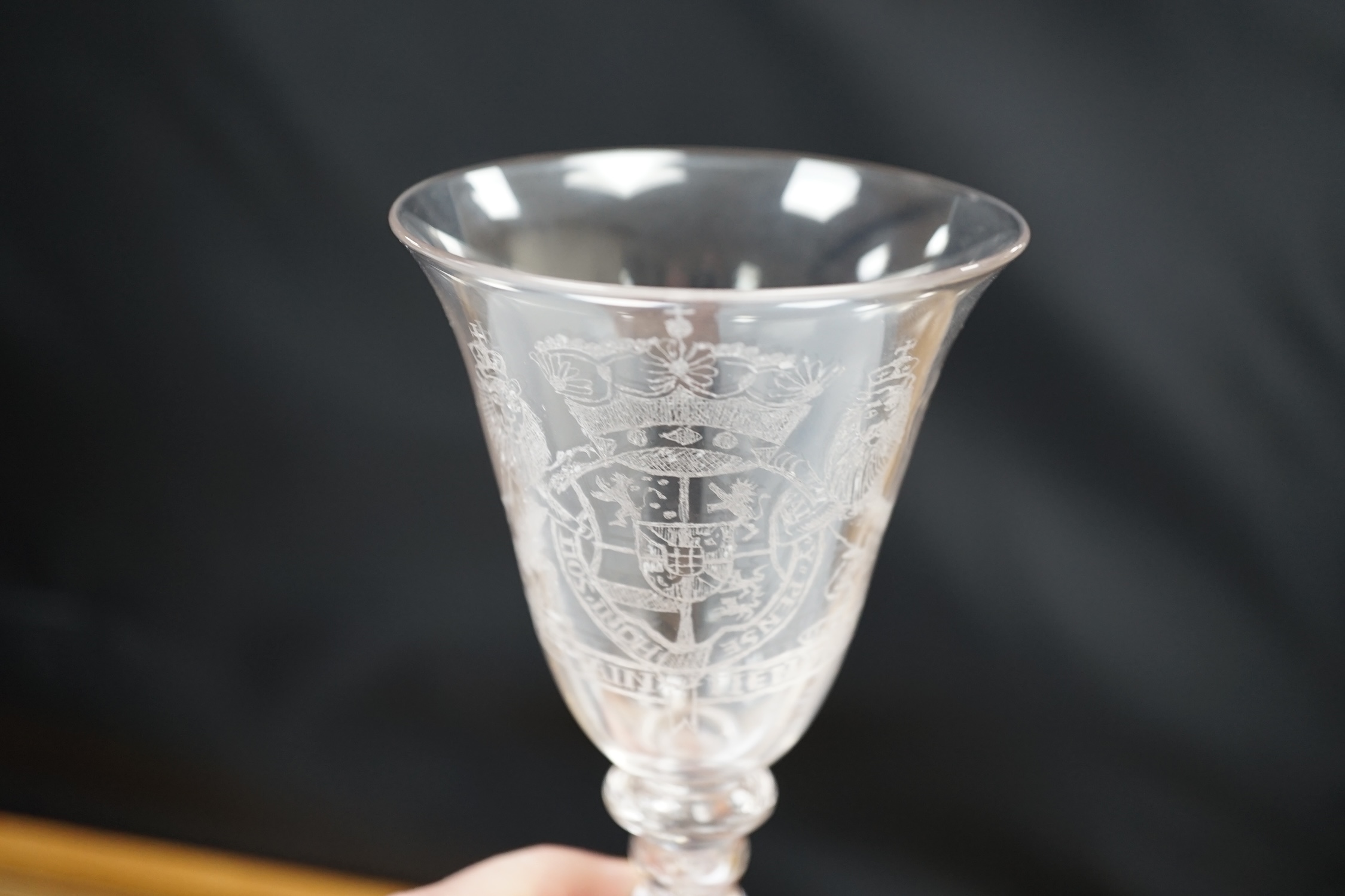 An 19th century diamond point engraved armorial glass, with knopped stem, air tears and rough pontil, 18cm